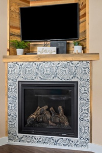 The gorgeous, new fireplace will keep your toes cold on a cold winter's day.