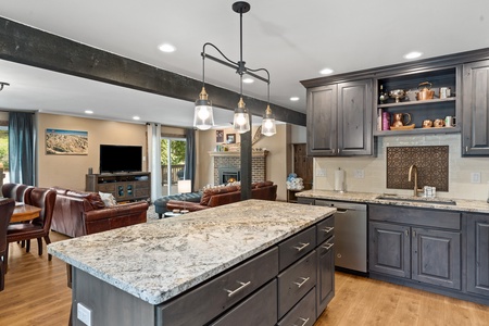 Large kitchen island, grey cabinets, grey finishings.