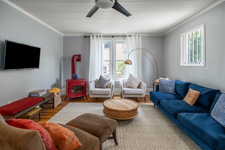 Blue couch, brown chair, TV