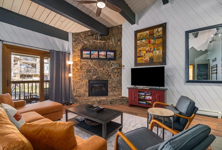 The living room features a smart TV, gas fireplace, and plenty of room to sit for the whole group.