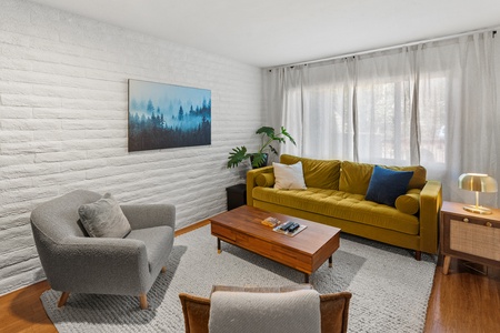 Yellow couch, 2 chairs, brown coffee table.