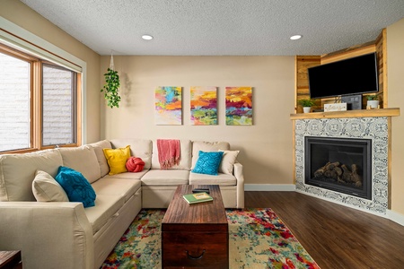 The bright, colorful living room pulls in natural light that lightens up the entire main level.