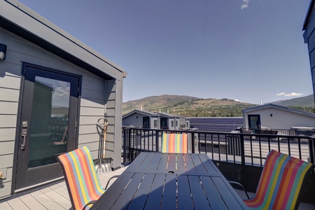 Private rooftop deck offers a table with seating as well as a hot tub with great mountain views.