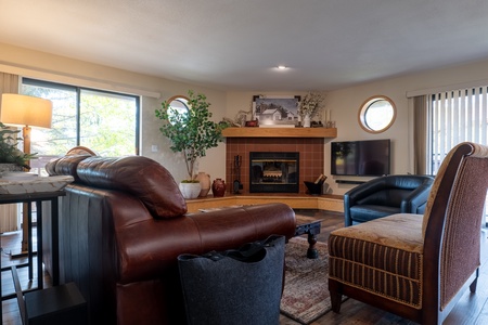 The cozy living area features a fireplace and multiple cozy seating options