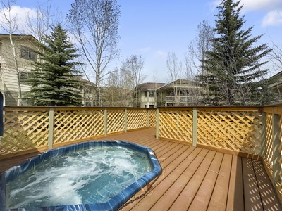 Communal hot tub on an outdoor deck.