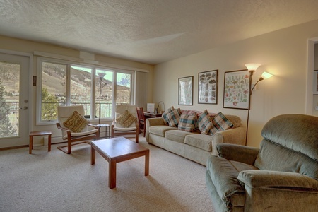 Cozy open concept living room with multiple seating options.