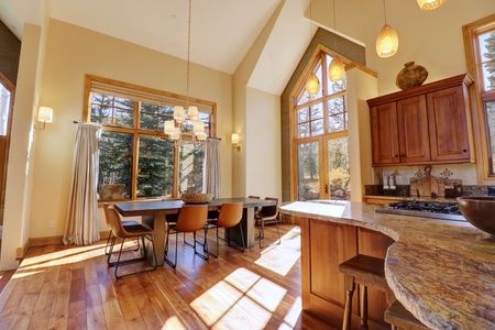 Large open concept dining and kitchen area. The home features large windows all around allowing ample natural light to come in.