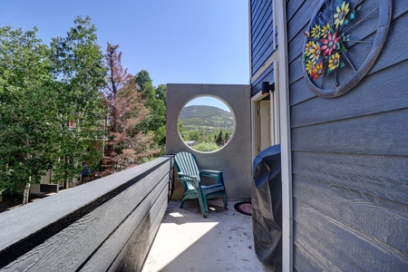 Private balcony offers great mountain views, seating, and a grill.