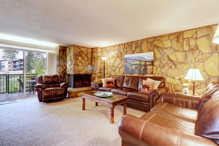 Cozy living room featuring a wood burning fireplace and cozy seating options.