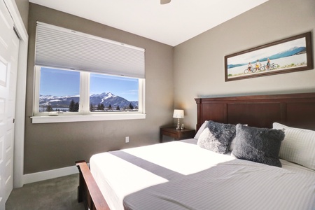 Master bedroom features picturesque views of Summit County mountains.