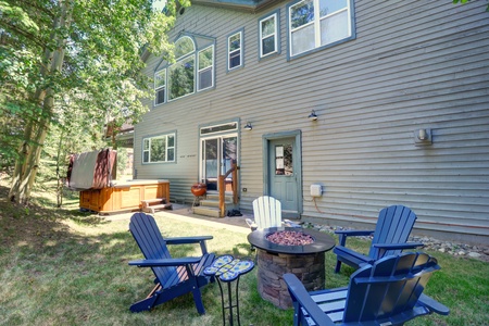 Beautiful backyard area with firepit and hot tub.