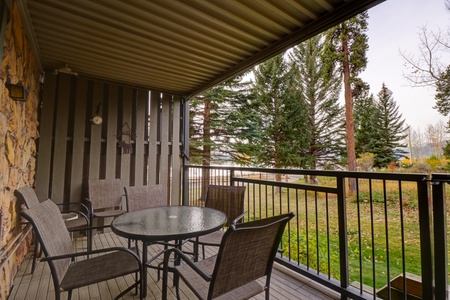 Private patio features a table with seating and access to the yard with a short walk down to Lake Dillon.