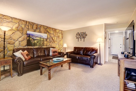 Cozy living room featuring multiple seating options.