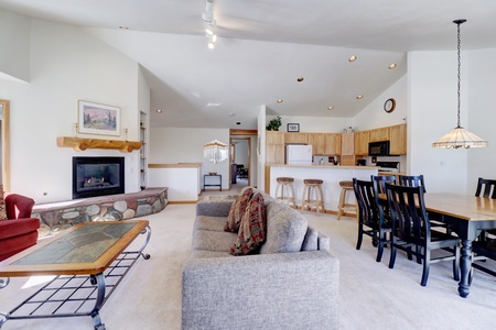 Large, open concept living, kitchen, and dining area on the upper level of the home.