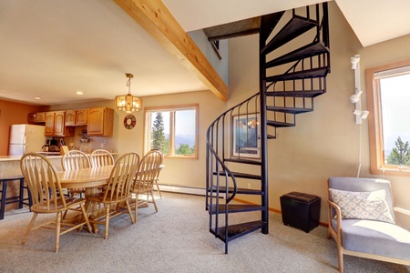 Open concept living, dining, and kitchen area. Stairway leading to upstairs rooms.