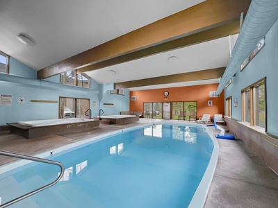 Indoor swimming pool area with a hot tub in the clubhouse