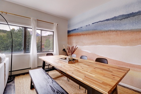 Large dining room table with great mountain views out of the window.