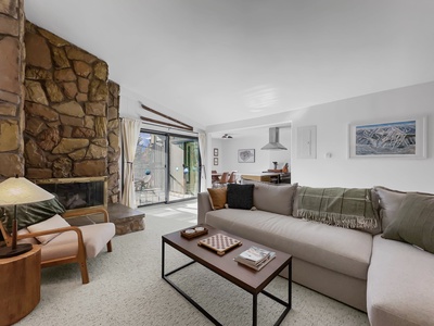 Open concept living area featuring a cozy fireplace and sofa.