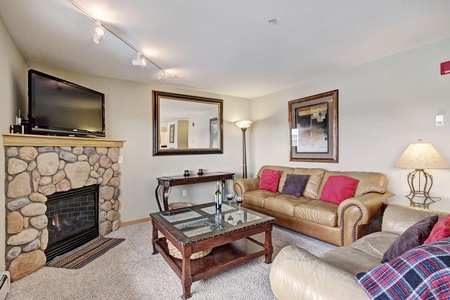 Cozy living room area with fireplace and TV