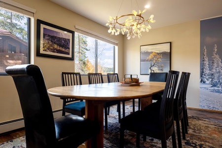 Large dining room table and window allowing natural light into the space