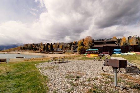 The backyard area features picnic tables and charcoal grills for communal use!