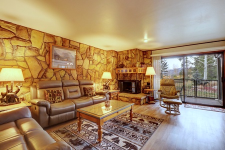 Living room features a gas fireplace and large windows and sliding door out to private patio.