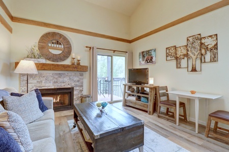 Cozy living room offers a fireplace, pull out sleeper sofa, and private deck.