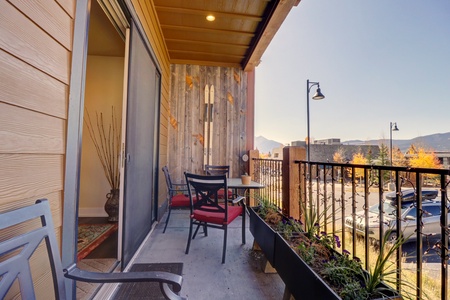 Private patio features a table with seating and great views.