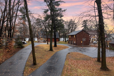 Street view of lakeside cabin with private driveway