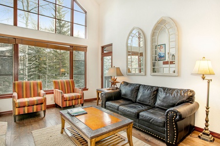 A living room with a couch and chairs.