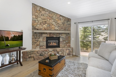 Cozy living area with stone fireplace