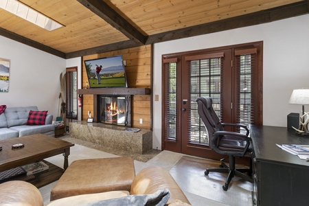 Living room with a stone fireplace