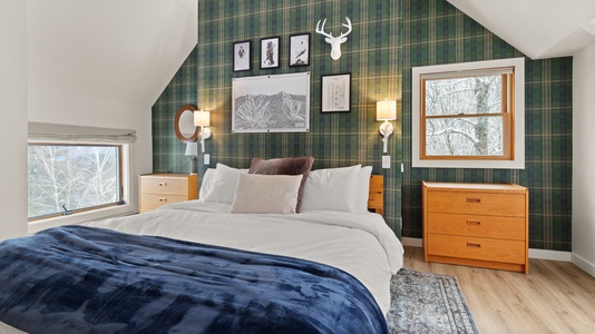 - Bedroom with plaid accent wall and cozy mountain decor   - Plush bedding and warm lighting create restful nights   - Artwork and rustic touches enhance alpine retreat feel