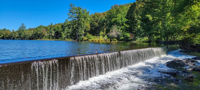 - Peaceful lake with waterfall surrounded by Vermont forest beauty - Scenic spot for relaxing walks nature photography or picnics - Enjoy calm water views just minutes from your vacation rental