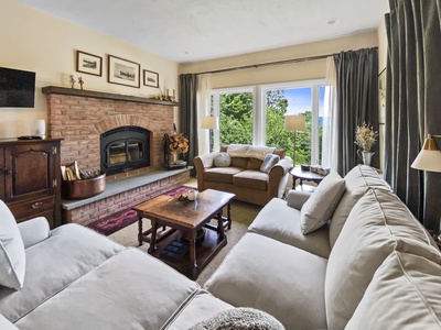 Downstairs Living Room with wood burning fireplace.  Relax after a long day of mountain fun.