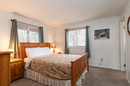 - Bright bedroom with queen bed and wooded window views   - Comfortable furnishings and cozy linens included   - Peaceful retreat for restful nights in the mountains