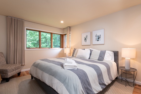 - Bedroom with king bed and crisp modern bedding   - Large window overlooking peaceful greenery   - Relaxing retreat perfect for restful nights