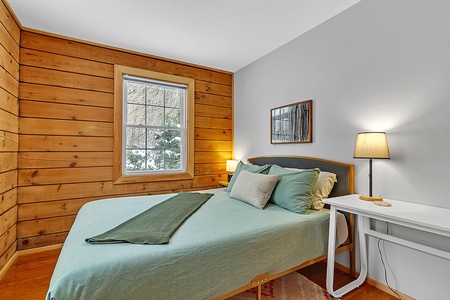 - Rest easy in a bright bedroom with soft linens   - Natural wood walls bring cozy cabin warmth inside   - Peaceful space to recharge after mountain adventures