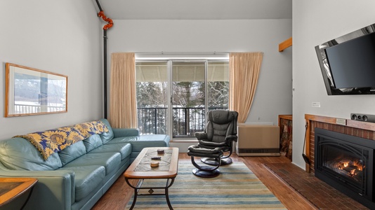 Cozy Living Room with Gas Fireplace and balcony through sliding doors