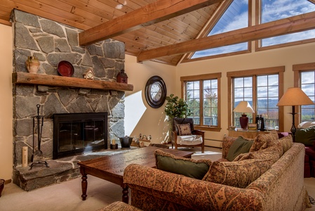 Cozy living room off the kitchen with fireplace and mountain views.