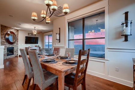 Dining area with lake views through wall-to-wall windows Dining area with lake views through wall-to-wall windows 