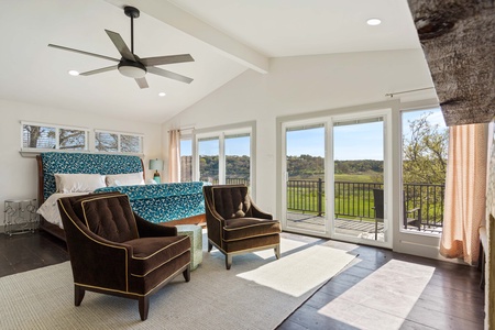 Primary bedroom with private balcony and views