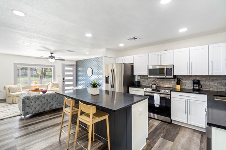 Renovated modern kitchen.  Gather around the island with bar stools