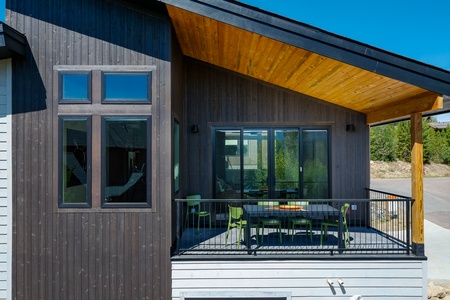 - Private balcony with outdoor dining and mountain view   - Covered space with modern furniture and fresh air   - Scenic outdoor retreat steps from the living room