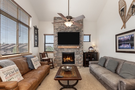 Living area with high ceilings, large windows bathing the space in natural light and plenty of seating for the whole group