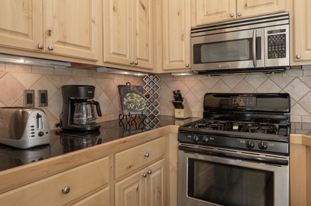 A two-slice toaster and a drip coffee pot for your use.