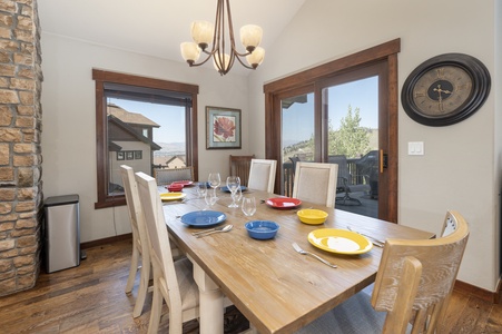 A dining room table with lush mountain views outside the windows