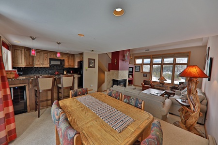 A cozy living and dining area with a large wooden table and chairs