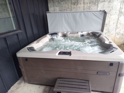 A brand new private hot tub under a covered deck