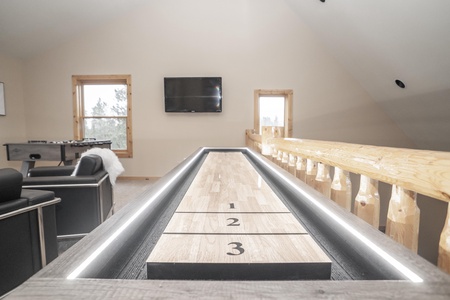 Loft game room with shuffle board and foosball